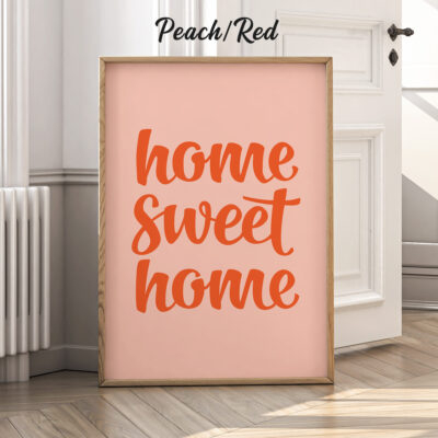 Peach red version of home sweet home poster leaning against wall.