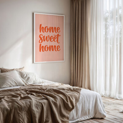 Home sweet home poster with retro script in peach red, styled in bedroom.