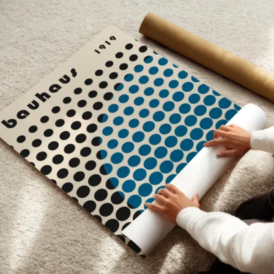 Playful Bauhaus poster showing a sweeping blue disc cutting through a field of black dots
