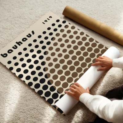Bauhaus poster showing black dot matrix intersected by a brown half-circle of dots