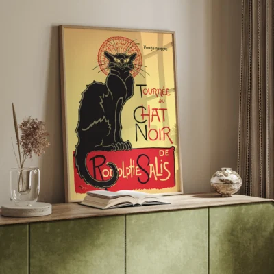 A vintage poster of a black cat with a halo, titled 'Tournée du Chat Noir de Rodolphe Salis', featuring yellow and red colors.