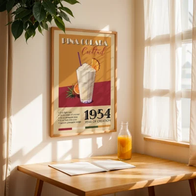 Framed poster of Pina Colada cocktail with recipe and year of creation, displayed in a sunlit room.
