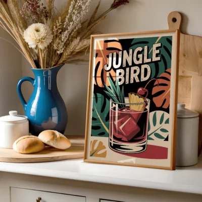 A framed poster of a Jungle Bird cocktail with tropical garnishes set in a kitchen
