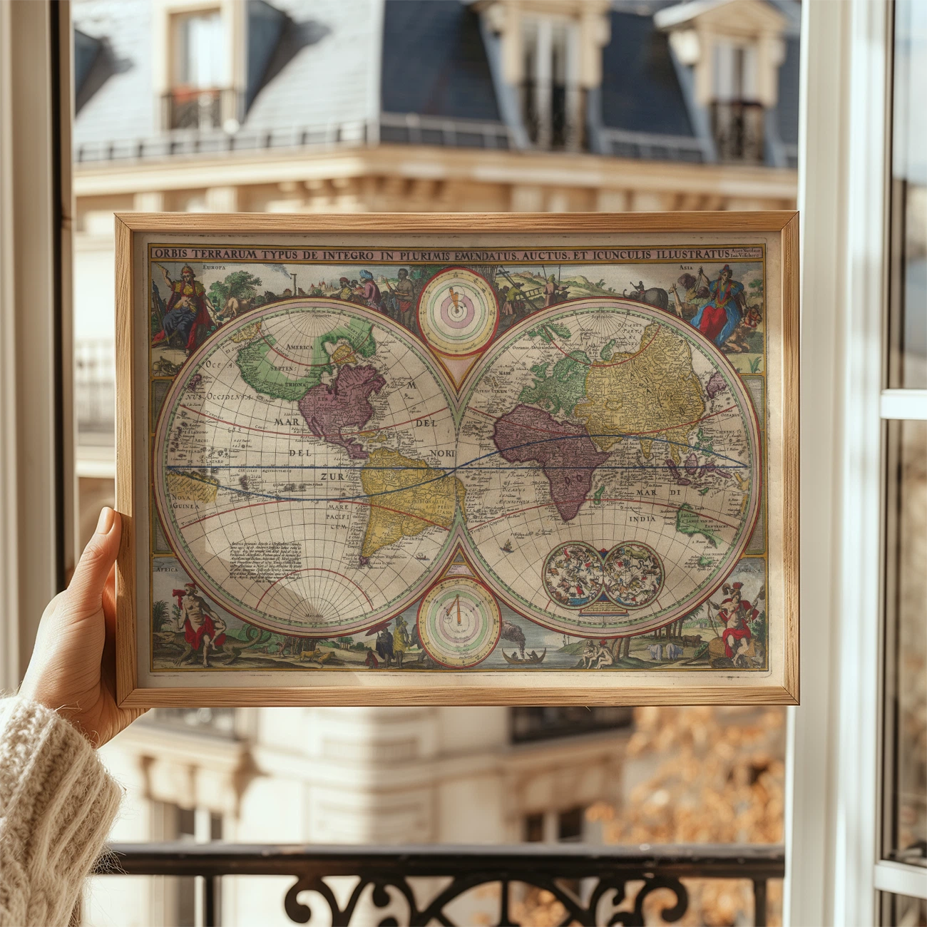 A person holding an antique world map framed in wood, with Parisian buildings visible through the window behind them.