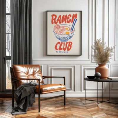 A cozy interior scene with a framed 'Ramen Club' artwork, featuring a bowl of ramen, a brown leather chair, and decorative plants.