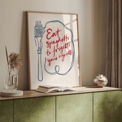 Framed wall art with a fork and spaghetti illustration along with the quote 'Eat spaghetti to forget your worries.'