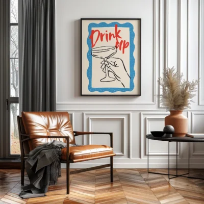 A cozy living room with a brown leather chair and a wall decorated with a framed art piece that says 'Drink Up' with a hand holding a martini glass.