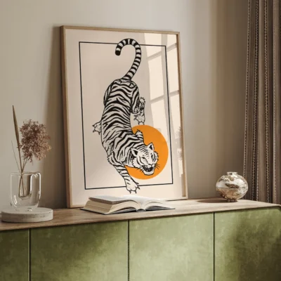 Illustration of a tiger leaping towards an orange circle inside a frame.