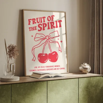A wall art print that says 'Fruit of the Spirit', featuring illustrations of cherries tied with a bow, and words representing various virtues.