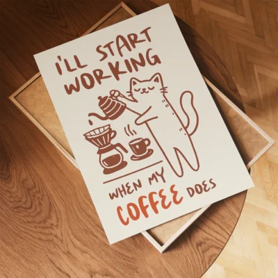 A playful cat illustration on a poster that says 'I'll start working when my coffee does' with a coffee pot and cups.