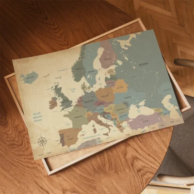 A vintage map of Europe displayed on a wooden table.