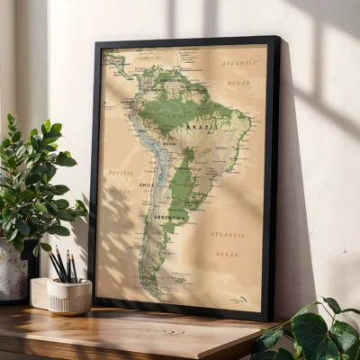 Framed map of South America in a living space, showcasing detailed geography with green highlighted areas and organized in a stylish black frame.