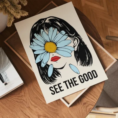 Illustration of a woman with dark hair and a daisy covering her face, with the text 'SEE THE GOOD' at the bottom.