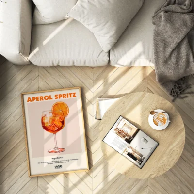 Aperol Spritz cocktail poster placed on floor next to chair, vintage bar illustration style.