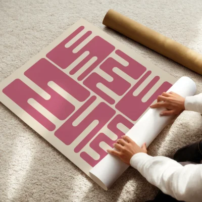 Bauhaus original poster print being rolled, pink wave typography in minimalist Bauhaus 1923 style.
