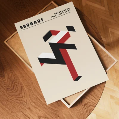 Art print Bauhaus running man poster flat lay on wooden floor, red geometric Bauhaus composition.