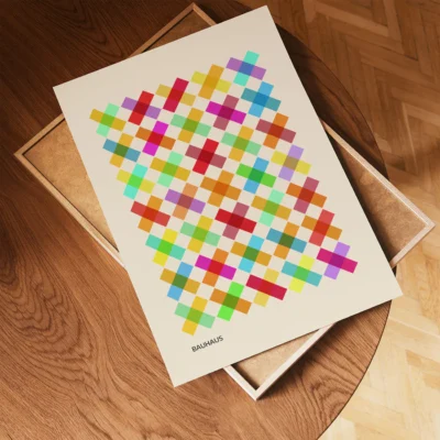 Unframed Bauhaus poster with diamond grid design on wooden table