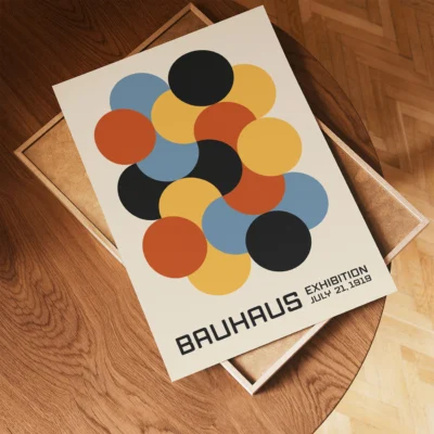Bauhaus art print laying flat on wooden surface, retro geometric poster with warm tones.