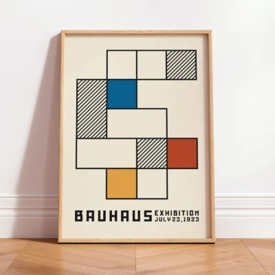 Minimalist wall decor Bauhaus poster leaning against wall, abstract geometric Bauhaus design in neutral tones.