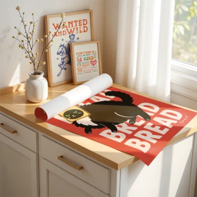 Rolled-up unframed cat poster with toast and "Bread" design on cabinet