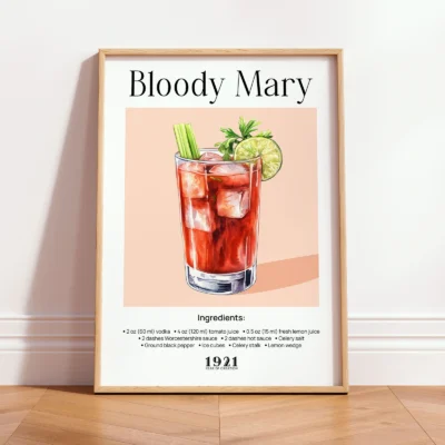 Framed Bloody Mary vintage cocktail print leaning against wall in a minimalist interior.