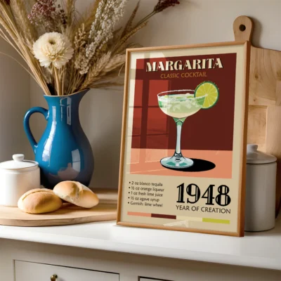 A vintage poster of a Margarita cocktail with a blue pitcher and baked rolls in the background.