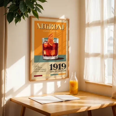 A poster of the Negroni cocktail with a glass of the drink, an orange slice garnish, and text indicating its creation year, placed on a table with a notebook and orange juice.