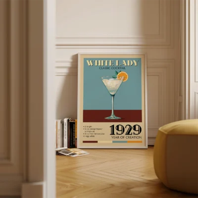 Vintage poster of the White Lady cocktail featuring a glass filled with a light-colored drink garnished with an orange slice, along with text describing the cocktail.
