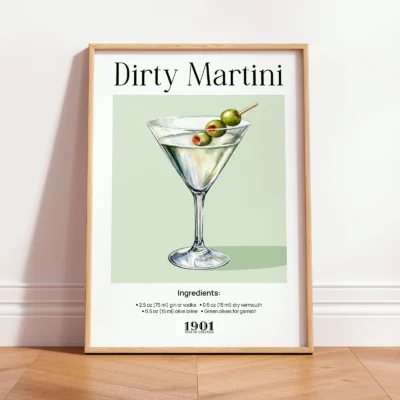 Framed Dirty Martini vintage cocktail print leaning against wall in a minimalist interior.