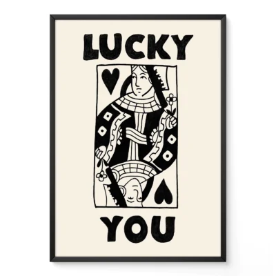Framed black and cream Queen of Hearts poster leaning against wall, hand-drawn retro playing card style.