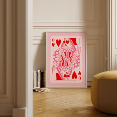 Queen of Hearts playing card poster standing on floor, pink and red retro illustration in minimalist room.