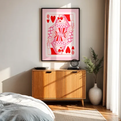 Pink and red Queen of Hearts playing card wall art above wooden cabinet in mid-century modern bedroom.
