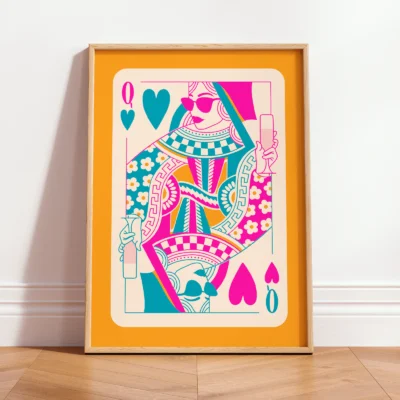 Colorful Queen of Hearts art print in yellow frame, leaning against wall in bright modern interior.