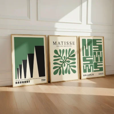Green Bauhaus poster set leaning on wooden floor against white wall