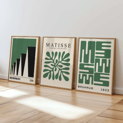 Bauhaus gallery wall print set in green leaning in sunlit minimalist room