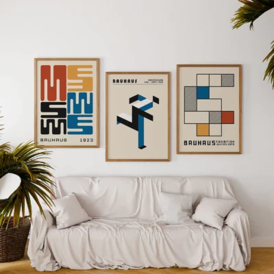 Posters set with colorful Bauhaus prints above soft white sofa
