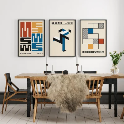 Bauhaus posters set in warm-toned dining area with wooden furniture