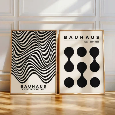 Two geometric Bauhaus prints leaning against wall in natural light