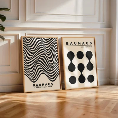 Poster pair of wavy and dotted Bauhaus prints leaning on white wall