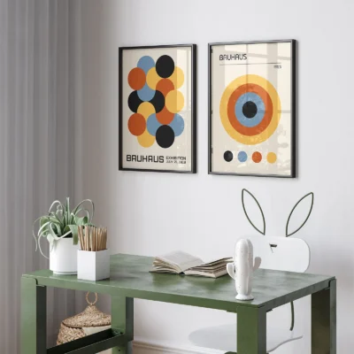 Minimalist Bauhaus posters with circular designs hanging above desk