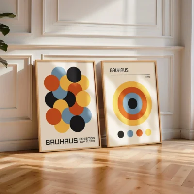 Poster set with orange and blue Bauhaus circle designs on wooden floor