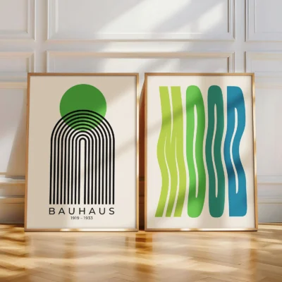 Two minimalist Bauhaus posters in green-blue palette leaning on wooden floor