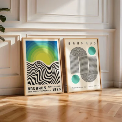 Floor-staged Bauhaus posters with bold lines and soft sunlight