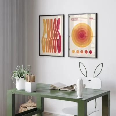 Two Bauhaus posters displayed above green desk workspace