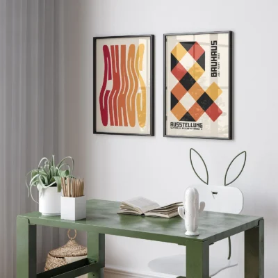 Minimalist Bauhaus prints displayed above green desk