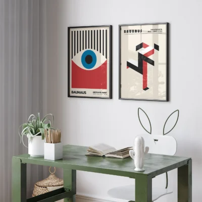 Clean Bauhaus prints framed above green desk