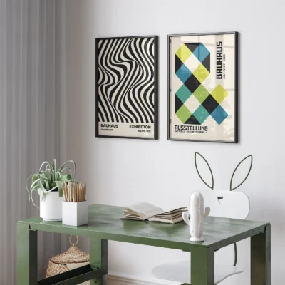 Green desk under two contrasting Bauhaus prints