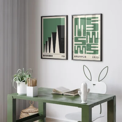 Green desk workspace with modern wall decor set of two prints