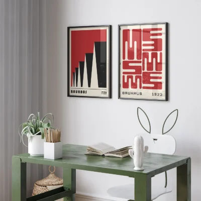 Workspace with black-framed 2 piece wall art set in red tones