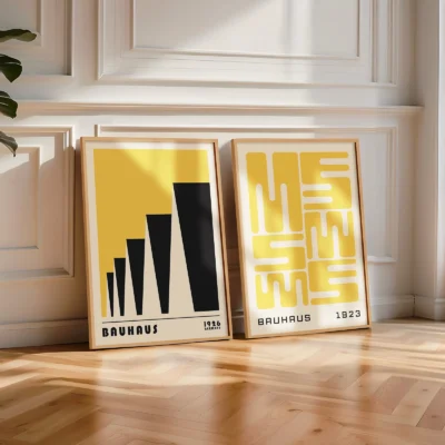 Geometric yellow poster set of 2 styled near a white paneled wall.
